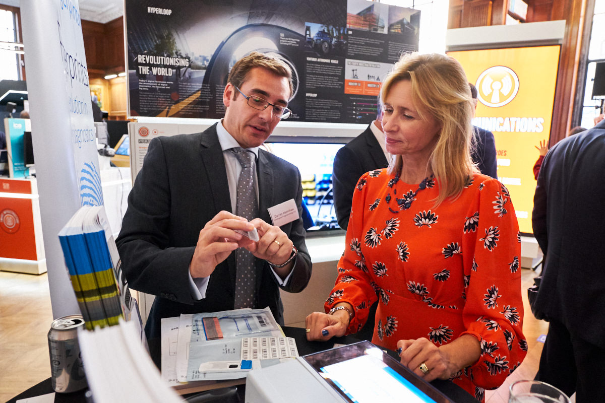 a technician showing a guest how fingerprint technology works