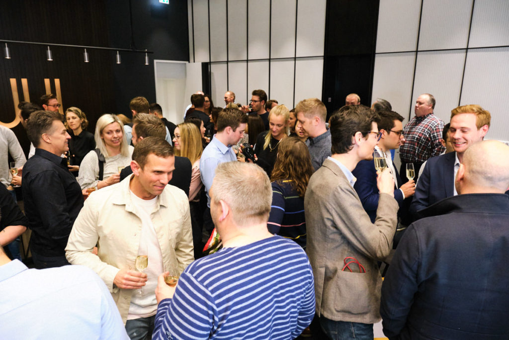 guests drinking and talking at an event in London offices