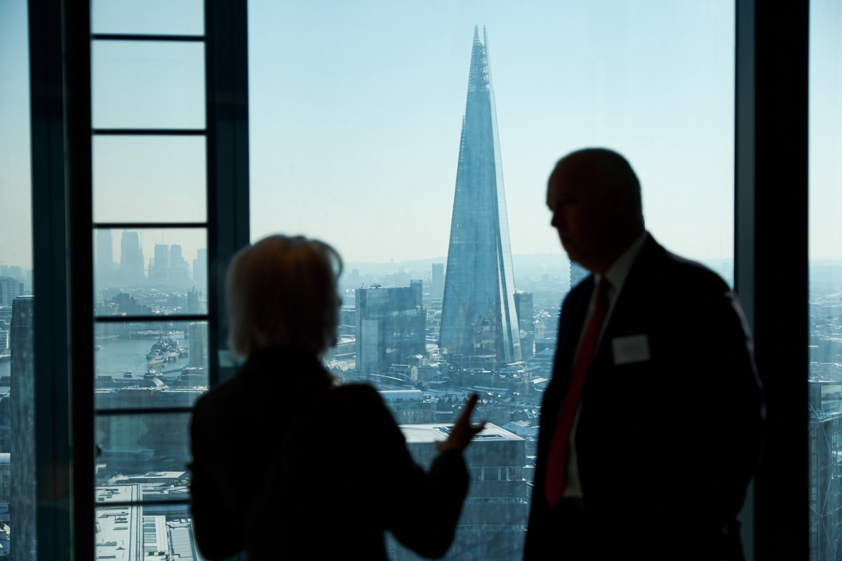 a man and woman silhouetted against the London skyline