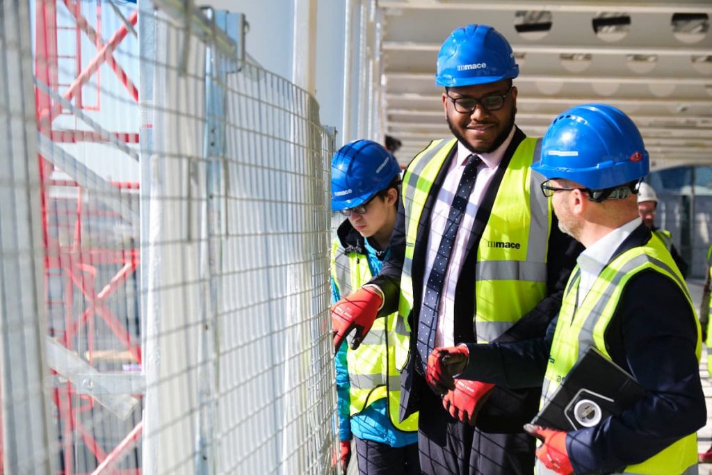 Visitors to a building site in London asking questions